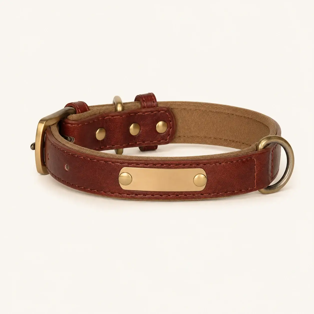 The whole brown collar photographed on white, the brass plate riveted flat on the strap